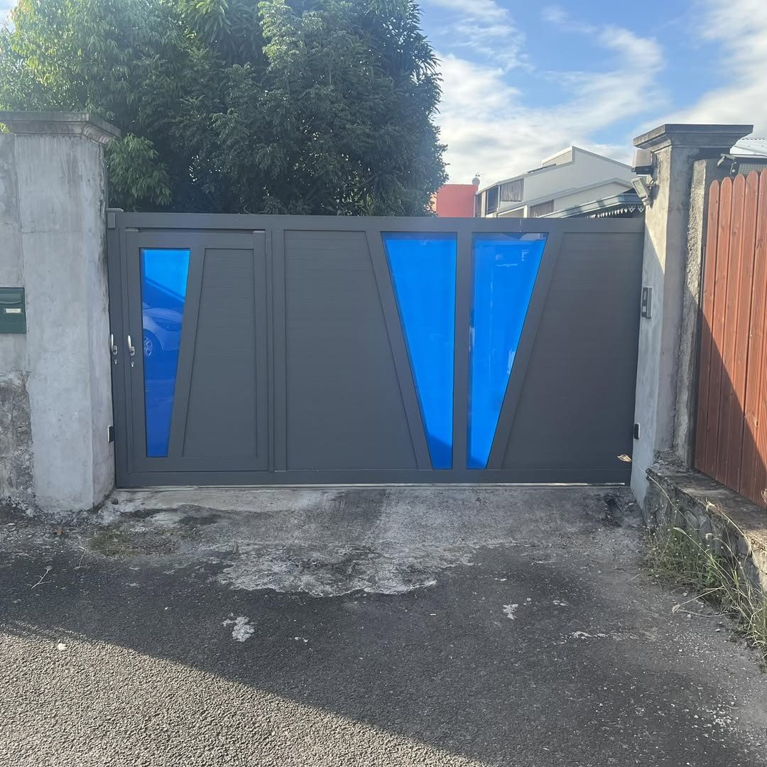 Portail aluminium gris anthracite à deux battants avec inserts bleus